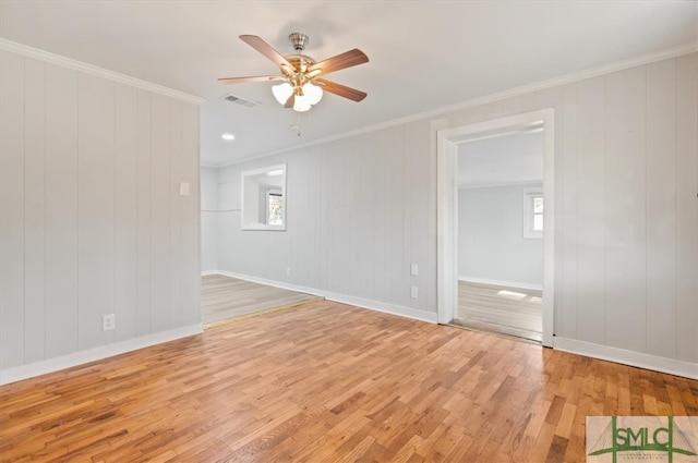 empty room featuring ceiling fan, a healthy amount of sunlight, and light hardwood / wood-style floors