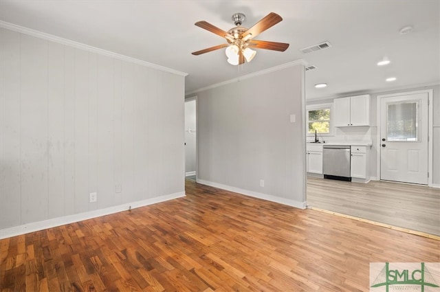 unfurnished living room with light wood-type flooring, ceiling fan, ornamental molding, and sink