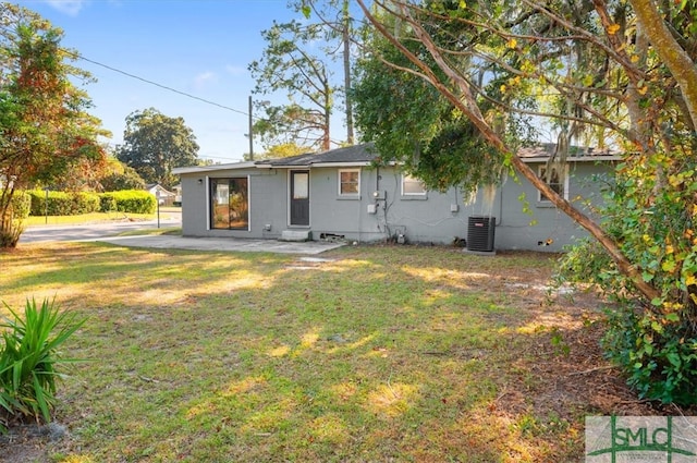 back of house with a lawn, a patio area, and central AC unit