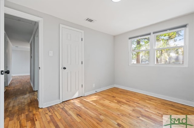 unfurnished bedroom with hardwood / wood-style flooring