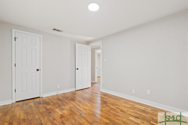 unfurnished bedroom with wood-type flooring