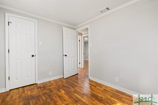 unfurnished bedroom featuring dark hardwood / wood-style flooring and ornamental molding