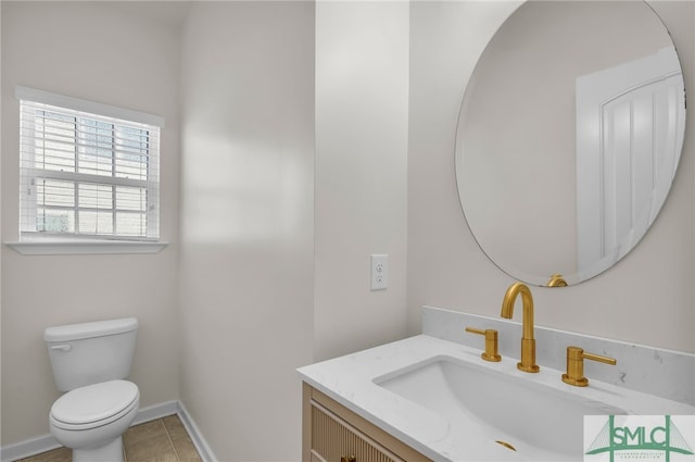 bathroom featuring vanity, toilet, and tile patterned flooring