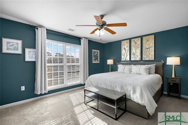 bedroom with carpet floors, a textured ceiling, and ceiling fan