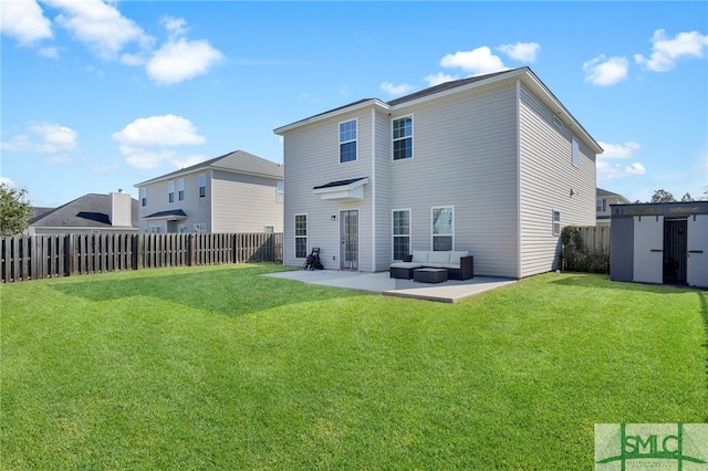 back of house featuring an outdoor living space, a storage unit, a yard, and a patio