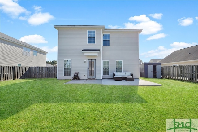 back of property with a patio, a storage unit, a yard, and an outdoor living space