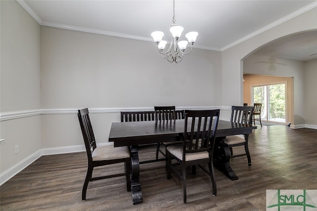 dining space featuring a notable chandelier, ornamental molding, and dark hardwood / wood-style flooring