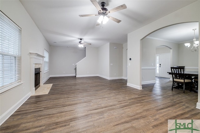 living room featuring crown molding, ceiling fan with notable chandelier, and dark hardwood / wood-style flooring