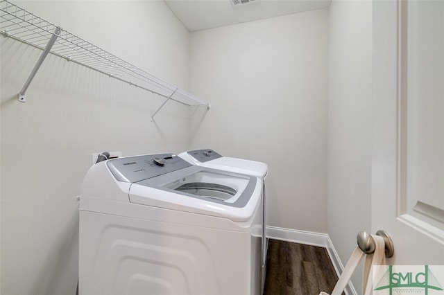 laundry room featuring washer and dryer and wood-type flooring