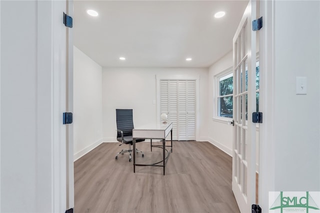 home office with light hardwood / wood-style floors