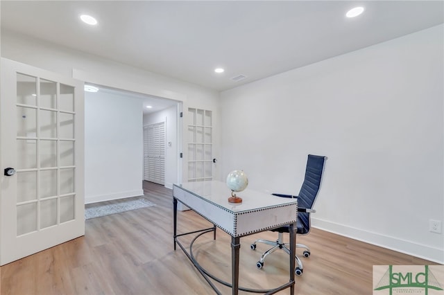 office space featuring light hardwood / wood-style floors and french doors