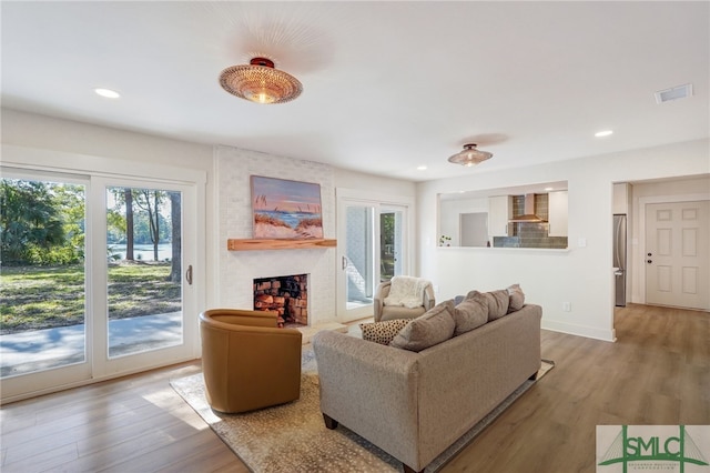 living room with a fireplace and hardwood / wood-style flooring