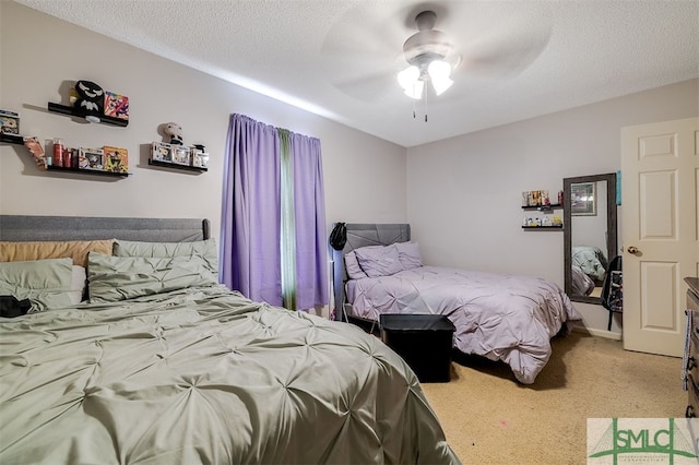 bedroom featuring a textured ceiling, carpet floors, and ceiling fan