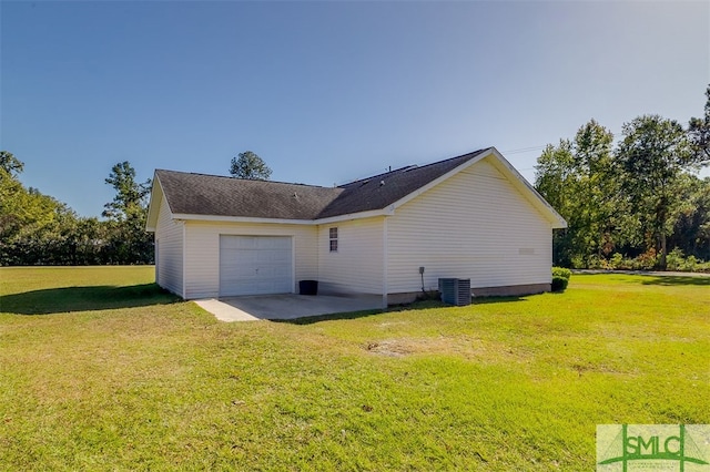 view of home's exterior with a yard, central air condition unit, and a garage