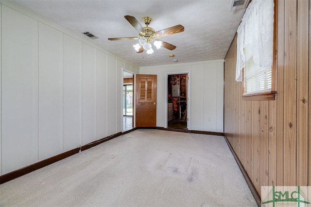 carpeted empty room featuring a textured ceiling and ceiling fan