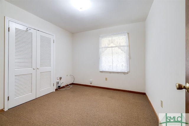 unfurnished bedroom with a closet and carpet floors