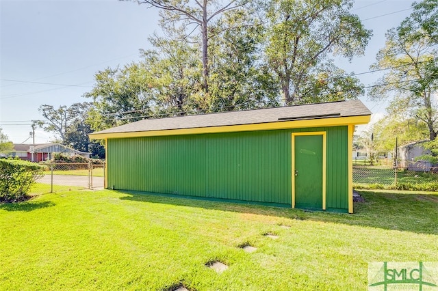 view of outbuilding featuring a lawn