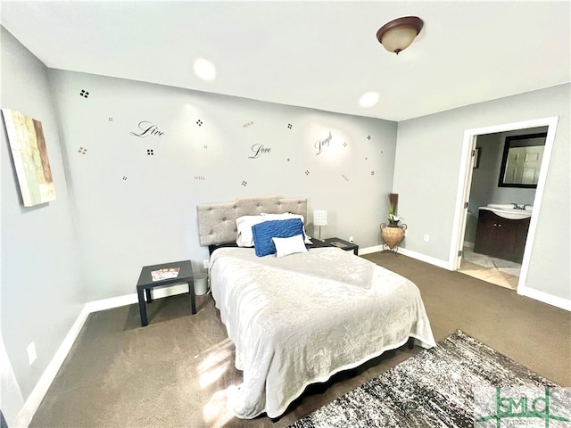 bedroom with carpet floors and connected bathroom