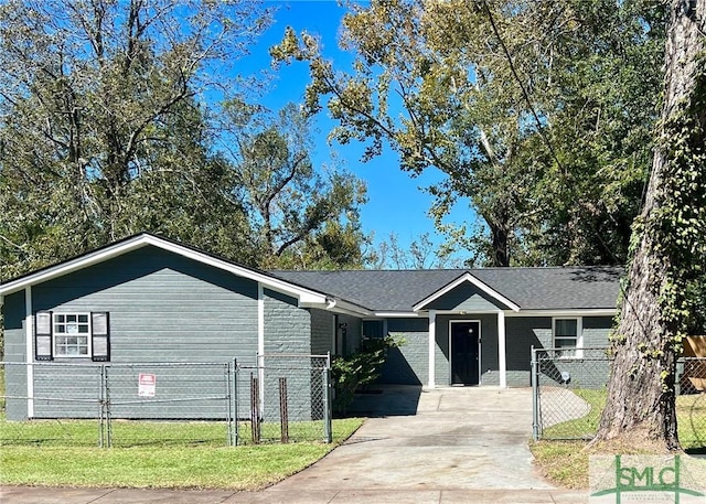 ranch-style house featuring a front lawn, fence, brick siding, a gate, and driveway
