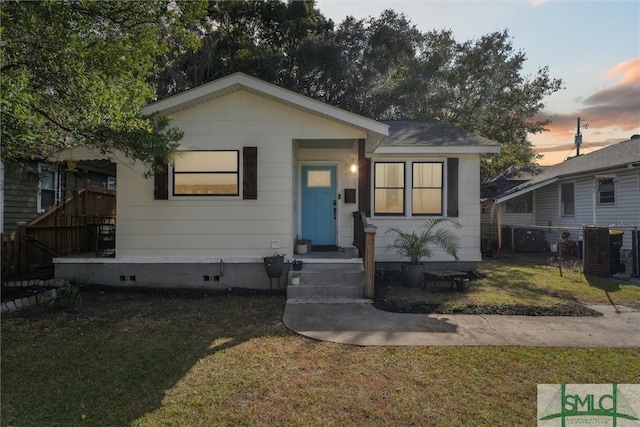 bungalow-style home featuring a yard