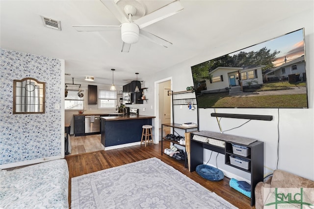 living room featuring dark wood-type flooring and ceiling fan