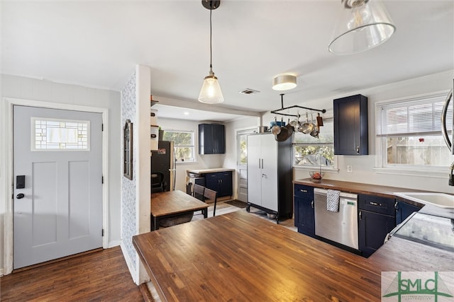 kitchen featuring dishwasher, butcher block counters, dark hardwood / wood-style floors, black refrigerator, and sink