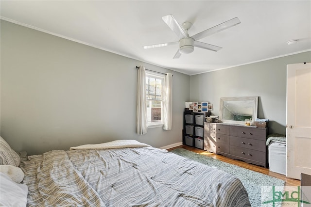 bedroom featuring crown molding, hardwood / wood-style floors, and ceiling fan