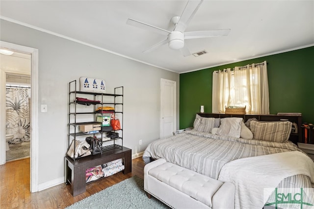 bedroom with ceiling fan, hardwood / wood-style flooring, and crown molding