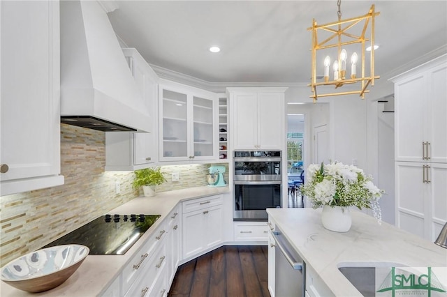 kitchen with stainless steel appliances, tasteful backsplash, custom exhaust hood, and white cabinetry