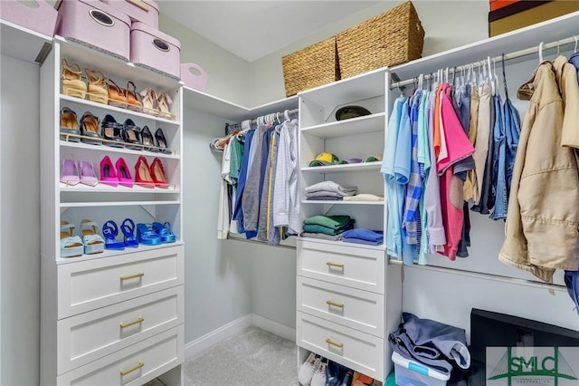 walk in closet featuring carpet