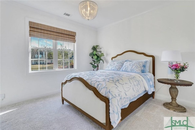 bedroom featuring an inviting chandelier, carpet flooring, visible vents, and baseboards