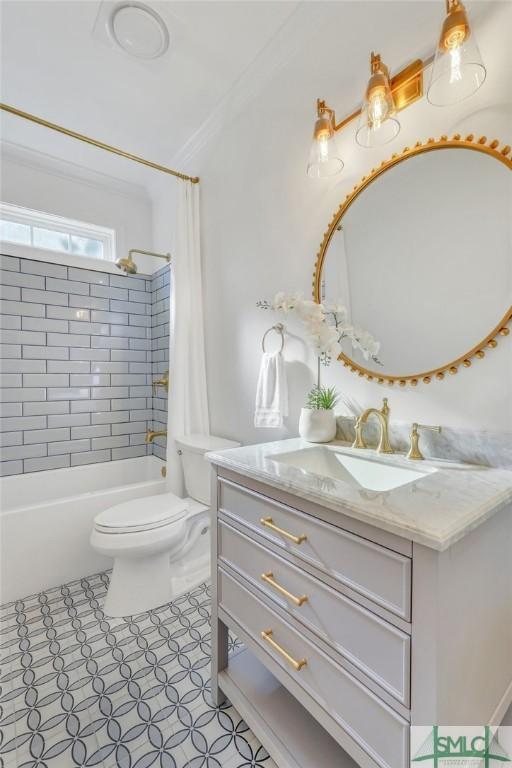 bathroom with tile patterned flooring, toilet, vanity, ornamental molding, and shower / bath combo