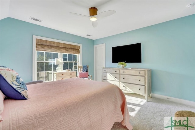 carpeted bedroom with ceiling fan, lofted ceiling, visible vents, and baseboards