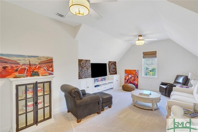 living area with carpet, visible vents, vaulted ceiling, ceiling fan, and baseboards