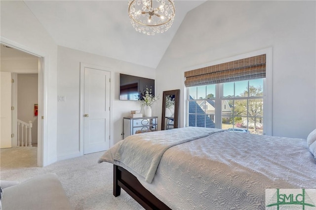 carpeted bedroom featuring a chandelier and high vaulted ceiling