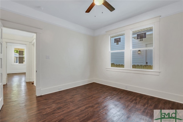 spare room featuring ceiling fan and dark hardwood / wood-style flooring