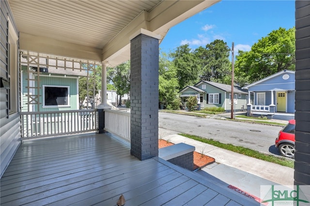 wooden terrace featuring a porch