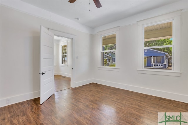 empty room with dark wood-type flooring, ceiling fan, and plenty of natural light