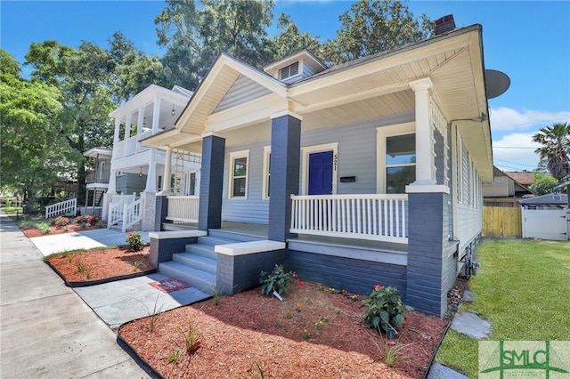 view of front facade with a front yard and a porch