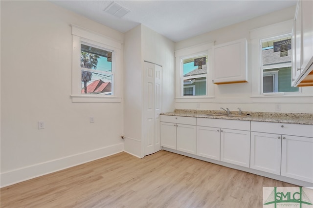 kitchen featuring white cabinetry and a healthy amount of sunlight