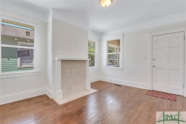 entryway with a fireplace and hardwood / wood-style flooring