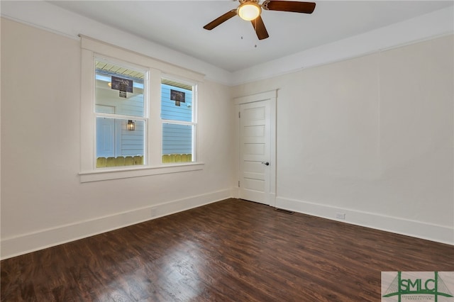 empty room with dark wood-type flooring and ceiling fan