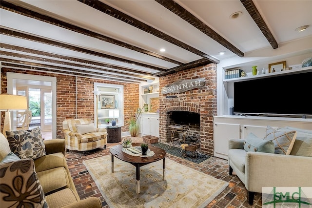 living room with beam ceiling, brick wall, and a brick fireplace