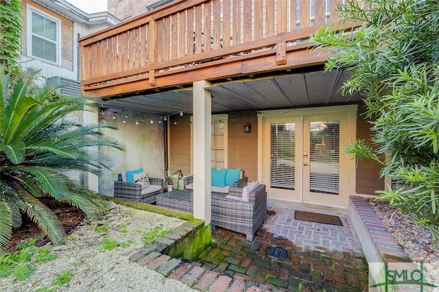 view of patio with outdoor lounge area, a wooden deck, and french doors