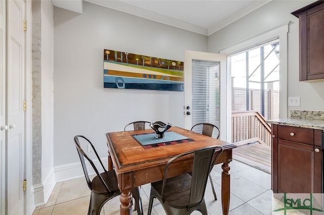 tiled dining area featuring crown molding