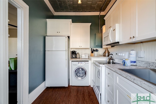 clothes washing area with washer / clothes dryer, crown molding, and dark wood-type flooring