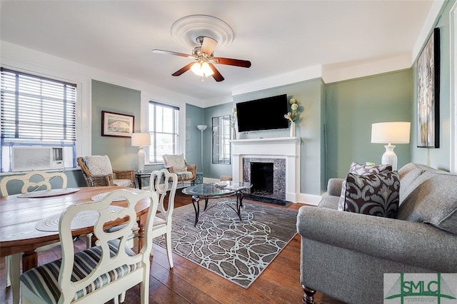 living room featuring dark hardwood / wood-style floors, cooling unit, a fireplace, and ceiling fan