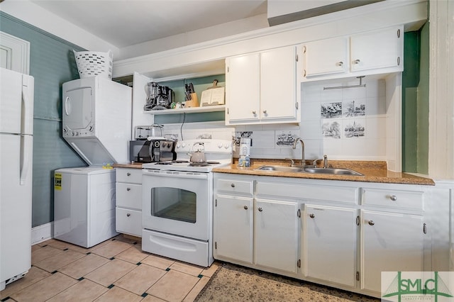 kitchen featuring white cabinetry, sink, stacked washer / drying machine, white appliances, and decorative backsplash