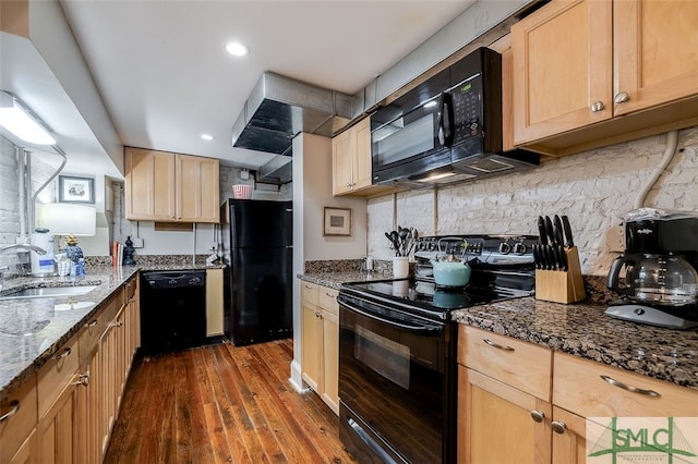 kitchen featuring light brown cabinets, dark wood-type flooring, black appliances, sink, and dark stone countertops