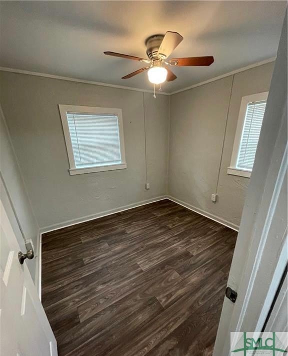 spare room with ornamental molding, ceiling fan, and dark hardwood / wood-style flooring